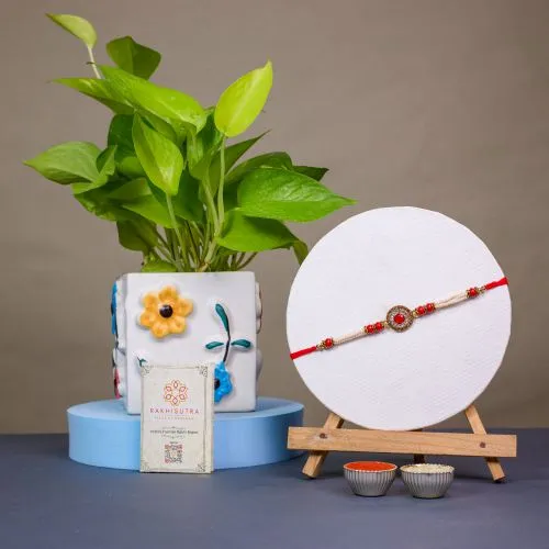 Elegant Kundan Rakhi with Golden Pothos